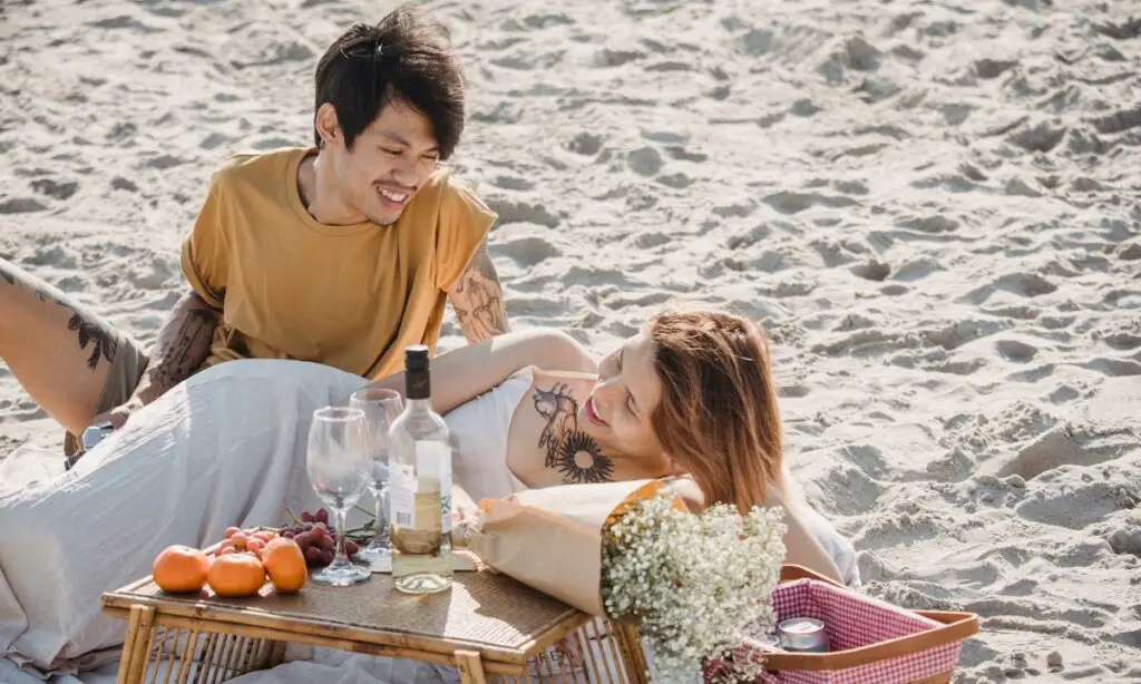 A young couple having a romantic meal at the beach