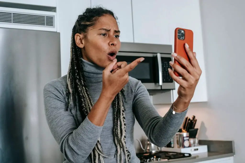 An angry woman pointing to phone